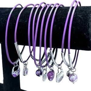 SET OF 10 PURPLE BRACELETS WITH SILVER TONE BARS AND CHARMS